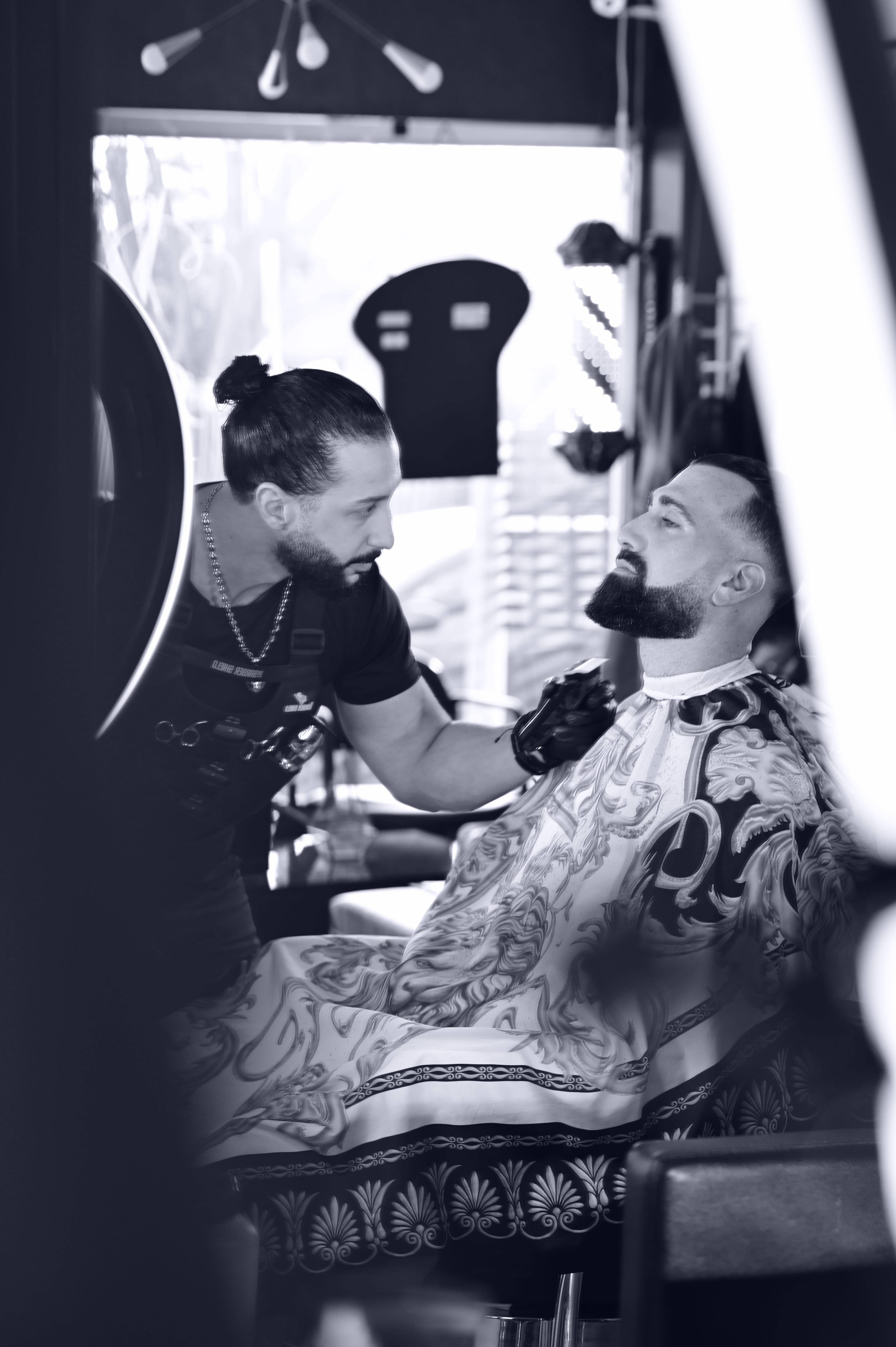 Barber finishing a beard at Salon Les Frères
